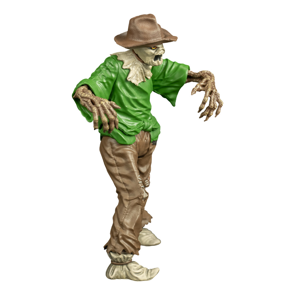 goosebumps scarecrow figure, right view.  Wearing a brown hat, burlap over head and neck, yellow eyes, jagged black mouth. Green shirt, light brown patched pants, cloth shoes tied around ankles.  Skeletal tan arms with long fingers and sharp claws.