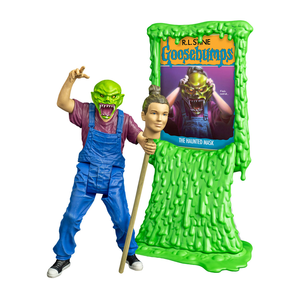 goosebumps figure, front view.  Wearing haunted mask,Bright green skin, no hair. Angry face with large ears, yellow eyes, large snarling mouth with sharp white teeth, pink tongue and gums. white drool on lower jaw and chin. Purple t-shirt, blue overalls, black and white sneakers.  Right arm bent at elbow raised over head.  left hand holding staff with person's head attached, brown hair pulled back in a bun.  shown next to Green slime book card stand