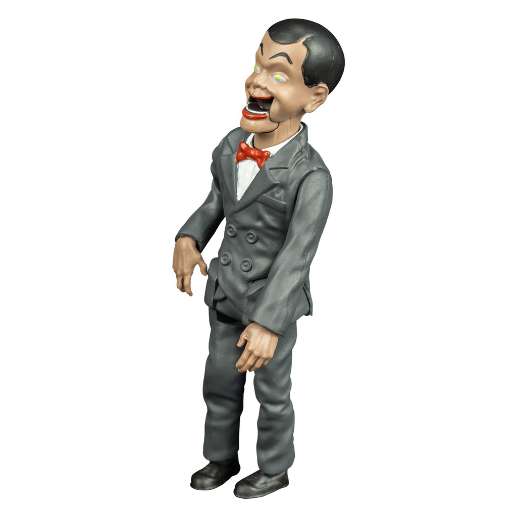 Goosebumps slappy figure, left view, Ventriloquist dummy face, dark hair and eyebrows, large yellow green eyes, bright red lips, open hinged dummy mouth showing teeth. white dress shirt, red bow tie. Gray suit coat and pants. black shoes.