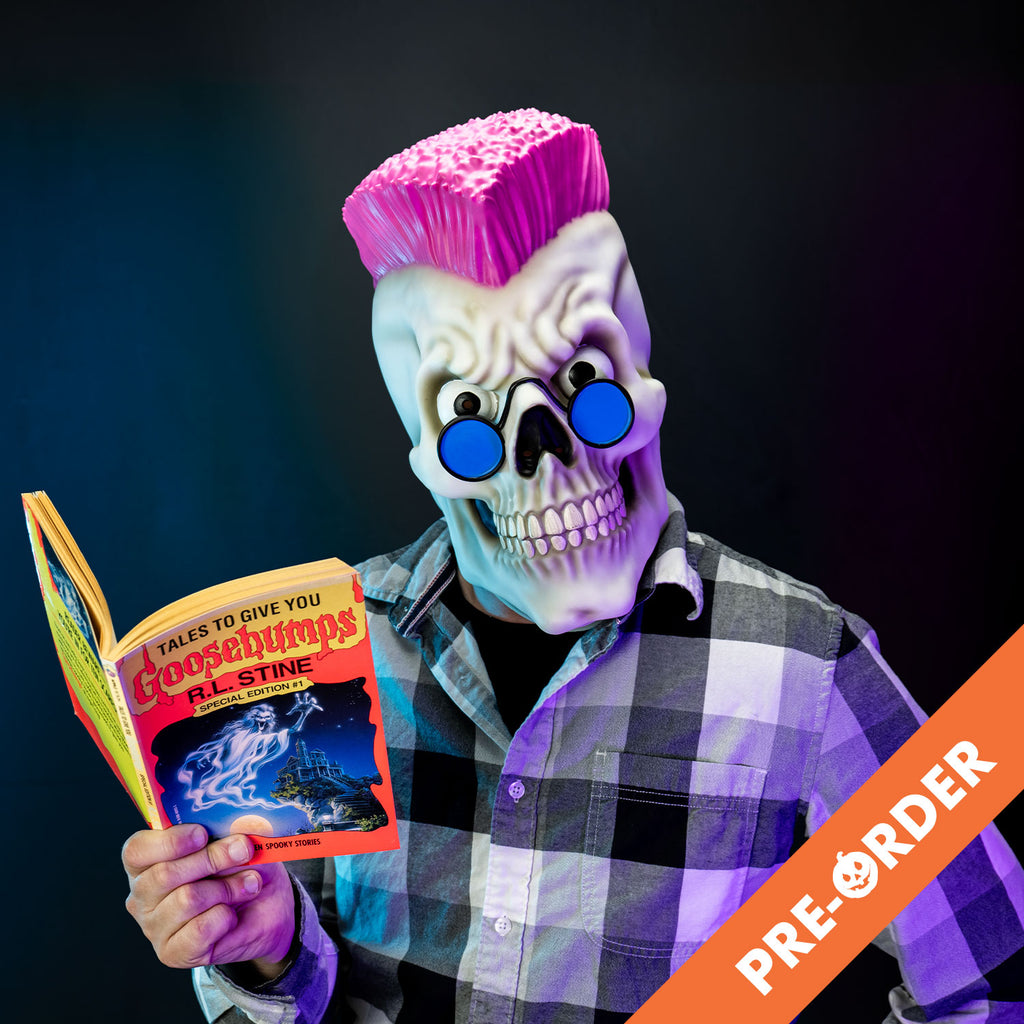 black background orange diagonal banner at bottom right, white text reads pre-order, Glam shot, man holding a Goosebumps book wearing black, white and gray flannel shirt and the Goosebumps curly mask, white grinning skull face, pink mohawk, large eyes, wearing blue round sunglasses. 