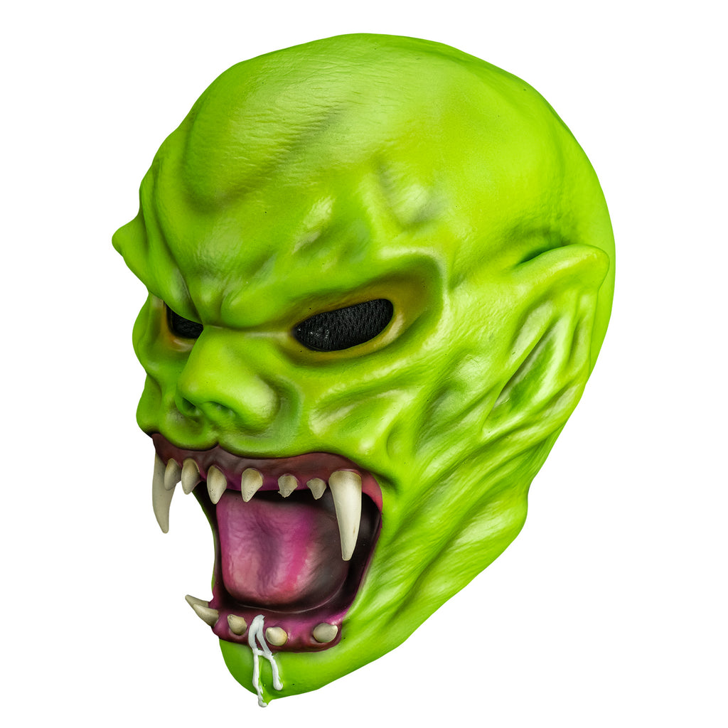 right side view. Bright green skin, no hair. Angry face with large ears, black eyes, large snarling mouth with sharp white teeth, pink tongue and gums.  white drool on bottom jaw and chin.