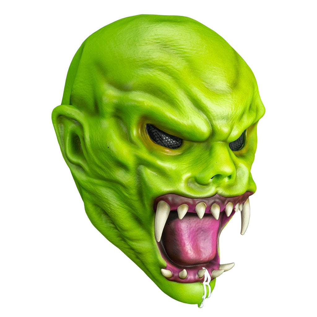 left side view. Bright green skin, no hair. Angry face with large ears, black eyes, large snarling mouth with sharp white teeth, pink tongue and gums.  white drool on bottom jaw and chin.