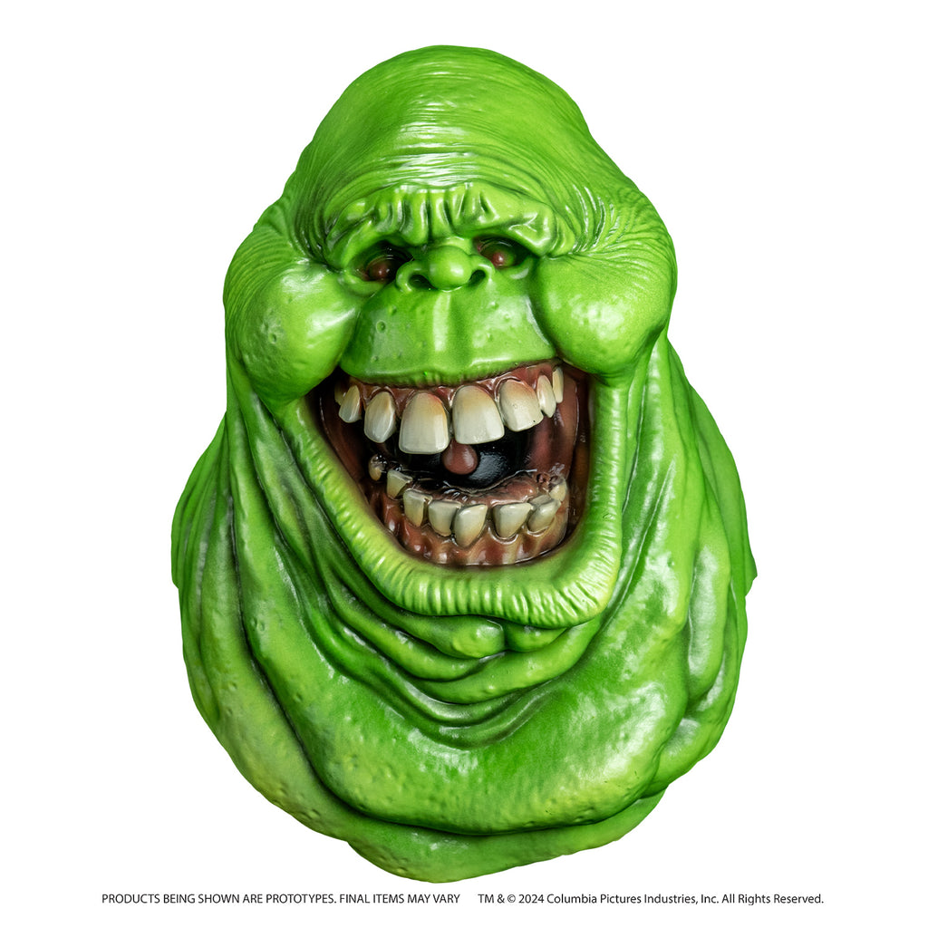Mask front view. Bright green ghost head and neck, lumpy blob with small eyes and nose, large open mouth showing large square teeth.