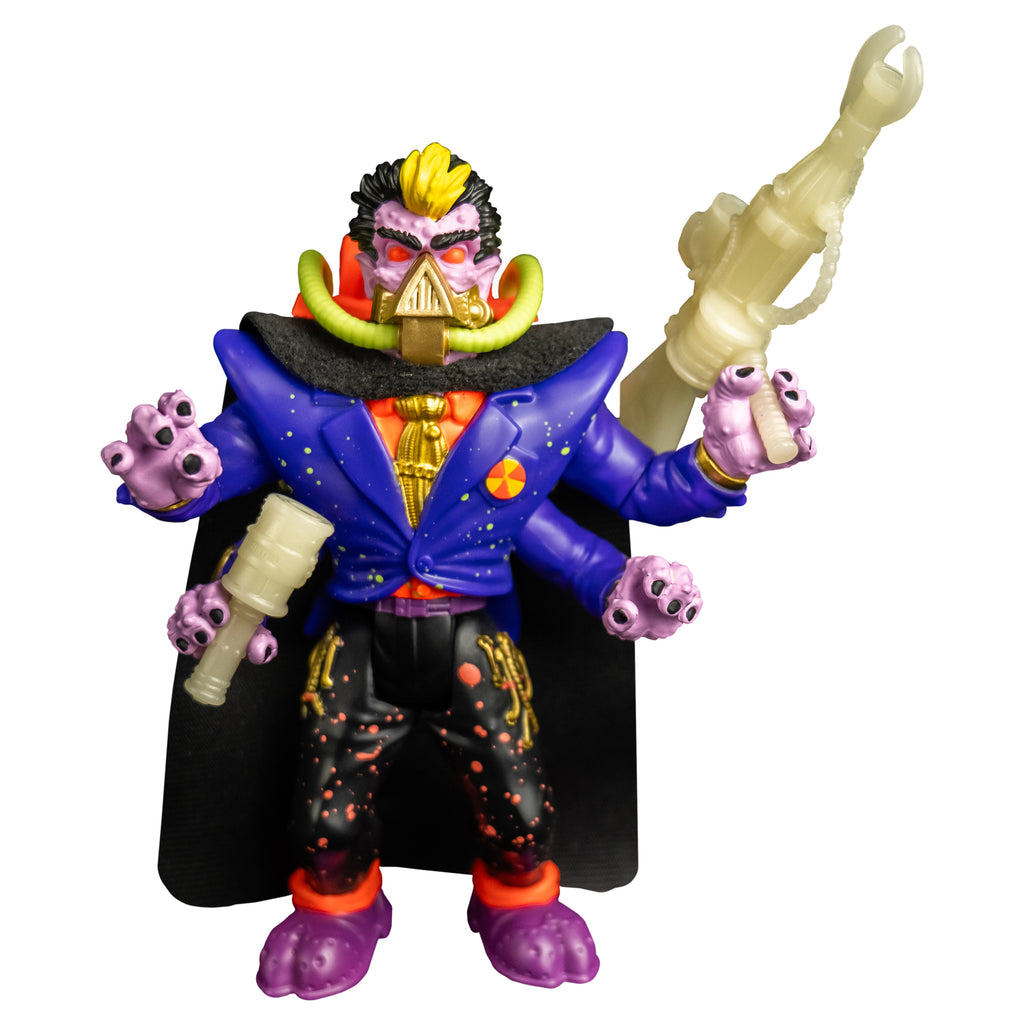  Action figure, front view. black hair, yellow stripe in the center front. Pale purple flesh. Black eyebrows, red eyes. gold mask, triangular over nose and mouth, horizontal bands around lower jaw, yellow hoses on sides attached to orange backpack. Wearing orange shirt, gold tie, blue jacket, four arms, black cape, black pants with orange splatter, purple and orange shoes. Holding accessory weapons in two hands