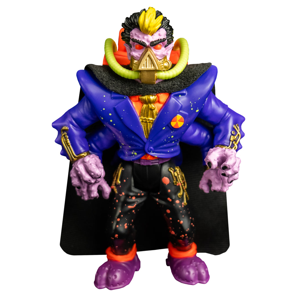 Action figure, front view.  Short black hair, yellow stripe in the center front. Pale purple bumpy flesh. Black bushy eyebrows, red eyes. gold mask, triangular over nose and mouth, horizontal bands around lower jaw, yellow hoses on sides attached to orange backpack. Wearing orange shirt with a gold tie, blue jacket, four arms, black cape, black pants with orange splatter, purple and orange shoes. 