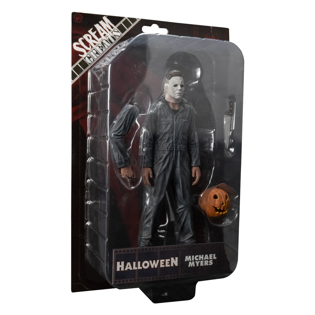 Product packaging slight right view. Blister packaging on cardboard backing. Contains the figure and right arm, kitchen knife and jack o' lantern accessories. White text on packaging reads Scream Greats, Halloween, Michael Myers. 