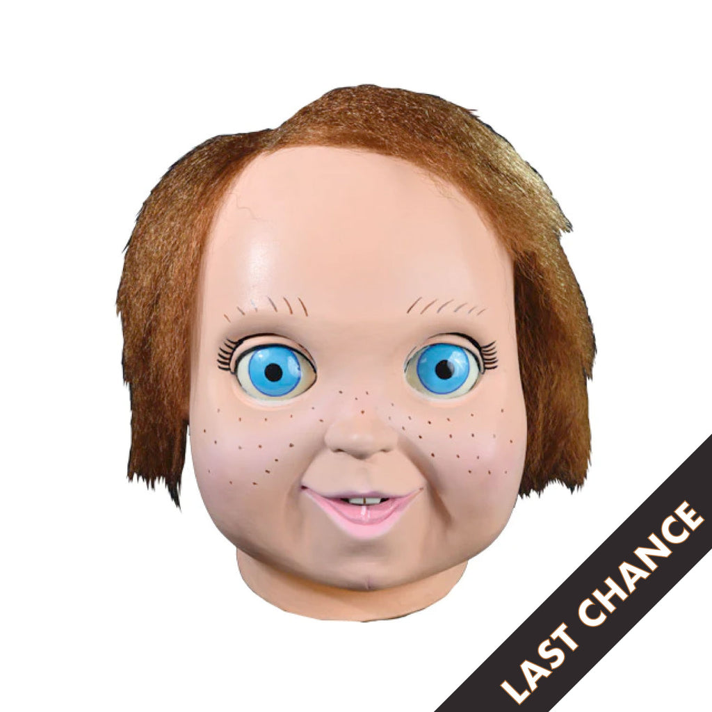 white background, black diagonal banner, bottom right corner, white text reads last chance. Front view. Good Guys Doll Mask. Head and neck. Red Hair, big blue eyes, freckles, happy face.
