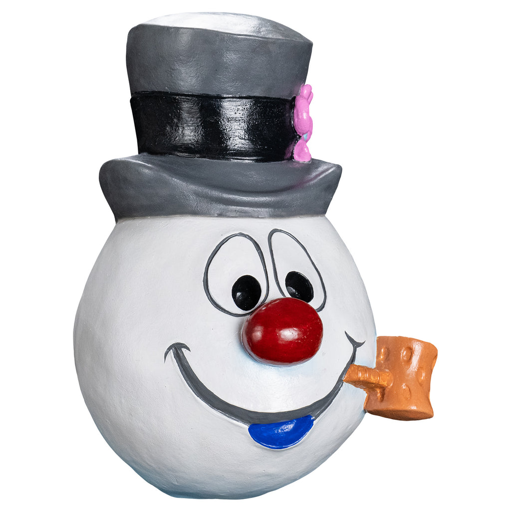 Mask, right side view. Cartoonish, white round snowman head, wearing a gray top hat with a black band and a pink flower on the left side. Face has large cartoon eyes, round red nose, gray cartoon mouth with blue bottom lip, tan pipe in the left corner of mouth.