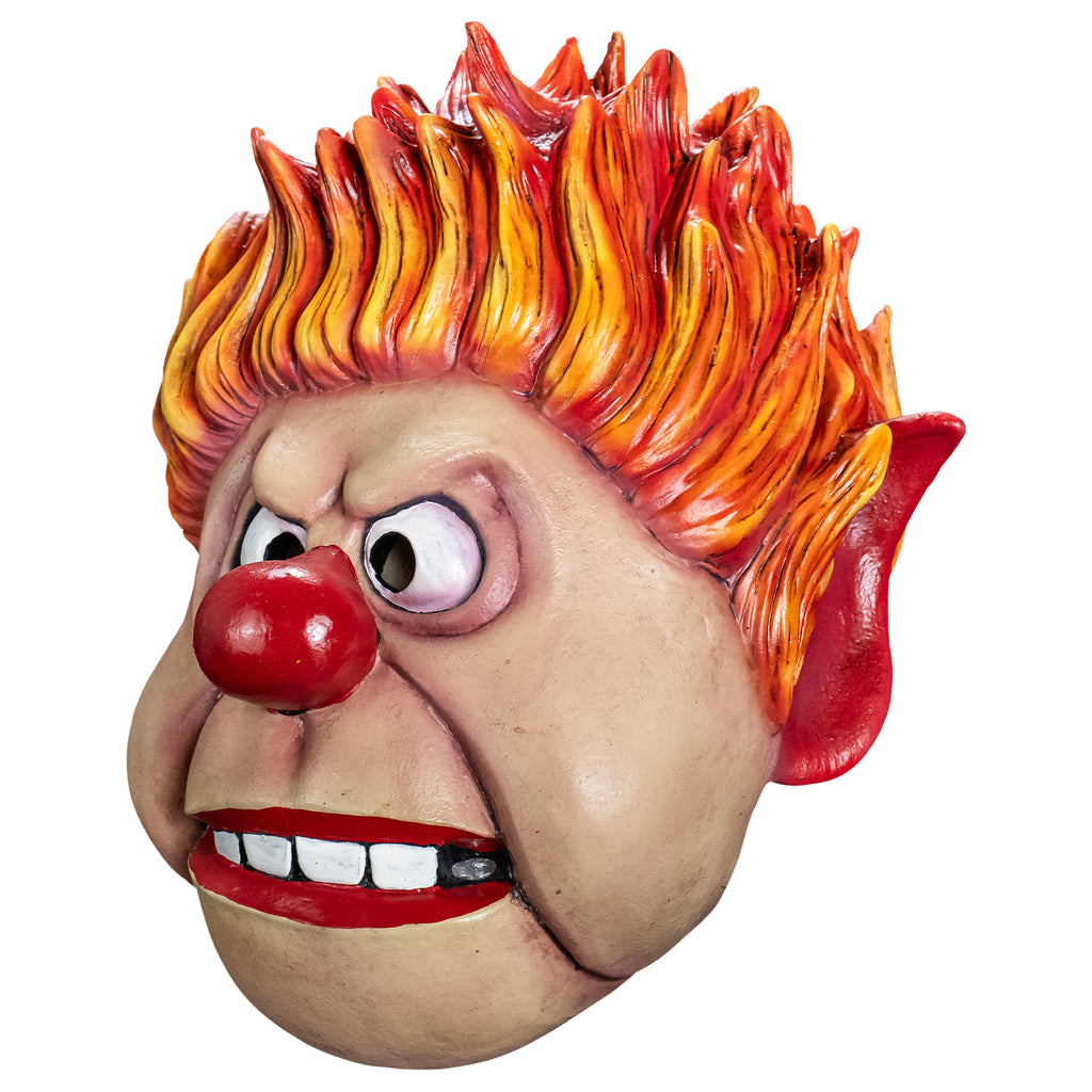 Mask, left side view. Cartoonish, round head, Yellow orange and red flame-like spiky hair, pointy red-tipped ears, furrowed brow, no eyebrows, large cartoon eyes, round red nose, prominent jowls, wide red-lipped mouth, slightly open showing large square white teeth.