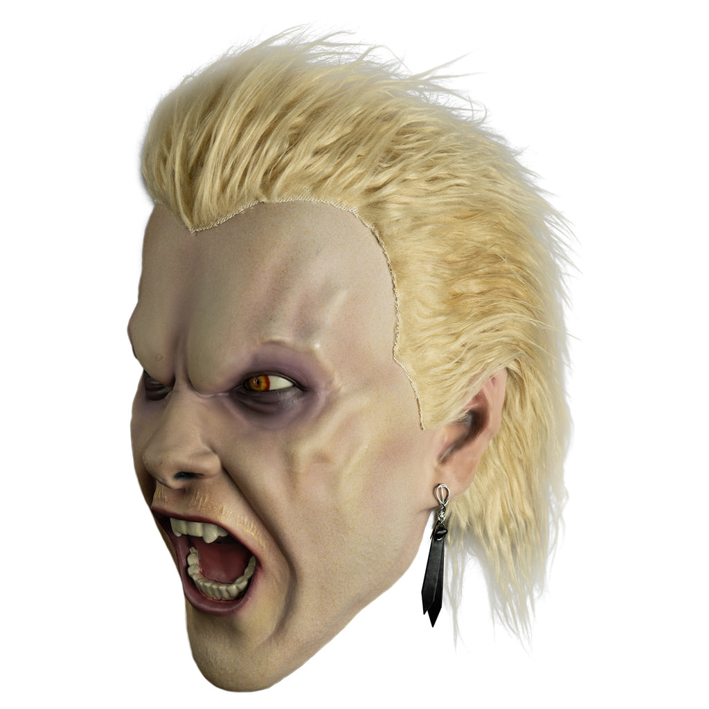 Mask, left view.  Light blond hair, slight mullet.  Furrowed brow, no eyebrows, dark circles under yellow eyes, long black earring in left ear, pale thin blond mustache,  mouth open in a snarl showing pink tongue and white teeth, fangs on either side of top two center teeth