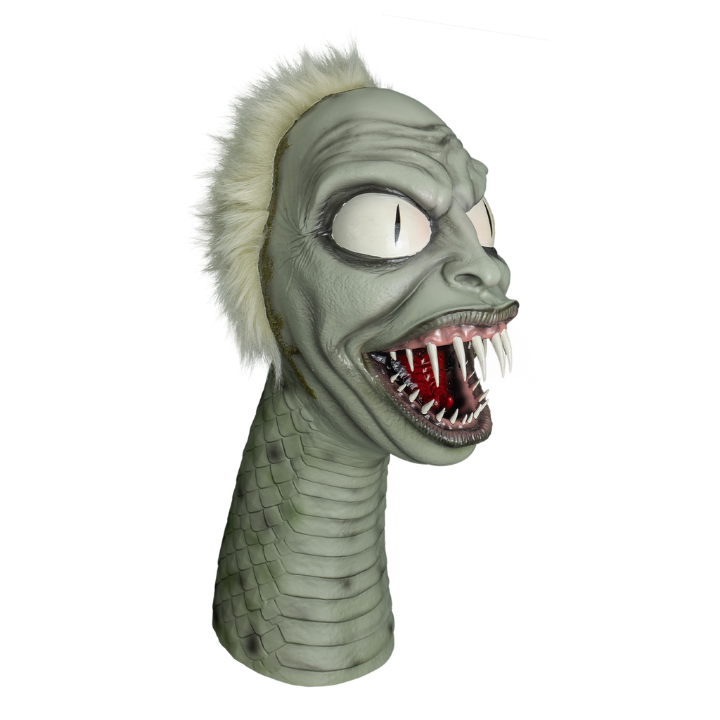 beetlejuice snake puppet, right view.  Gray flesh, spiky white hair on head, human-like face, wrinkled brow, large white eyes with vertical pupils.  Large mouth with gray and pink lips, wide open showing several sharp teeth in pink gums and a red forked tongue.  green crust on left corner of mouth and around hairline.  long snake neck with horizontal scales on front rounded scales on side and back.