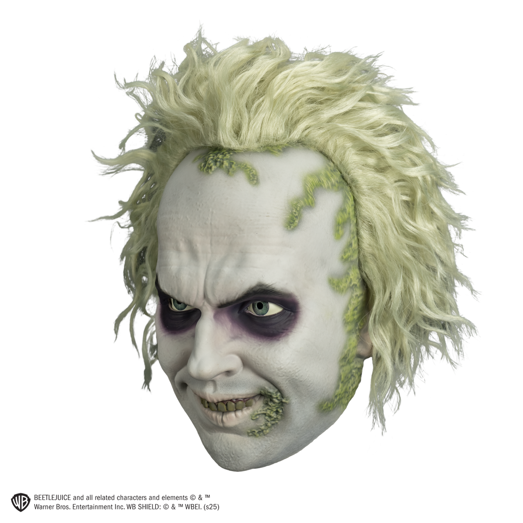 beetlejuice mask left view.  White hair and skin, wrinkled brow, black around eyes. smiling mouth showing green upper teeth.  green crusts around hairline and on left corner of mouth.