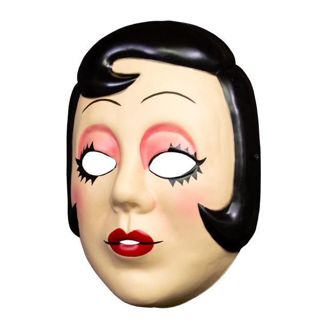 Plastic face mask, left view. Woman's face, short black hair with curl on right side of forehead and at cheeks. Thin penciled eyebrows, empty eyeholes, spiky black eyelashes, pink eyeshadow. Small round red lips.