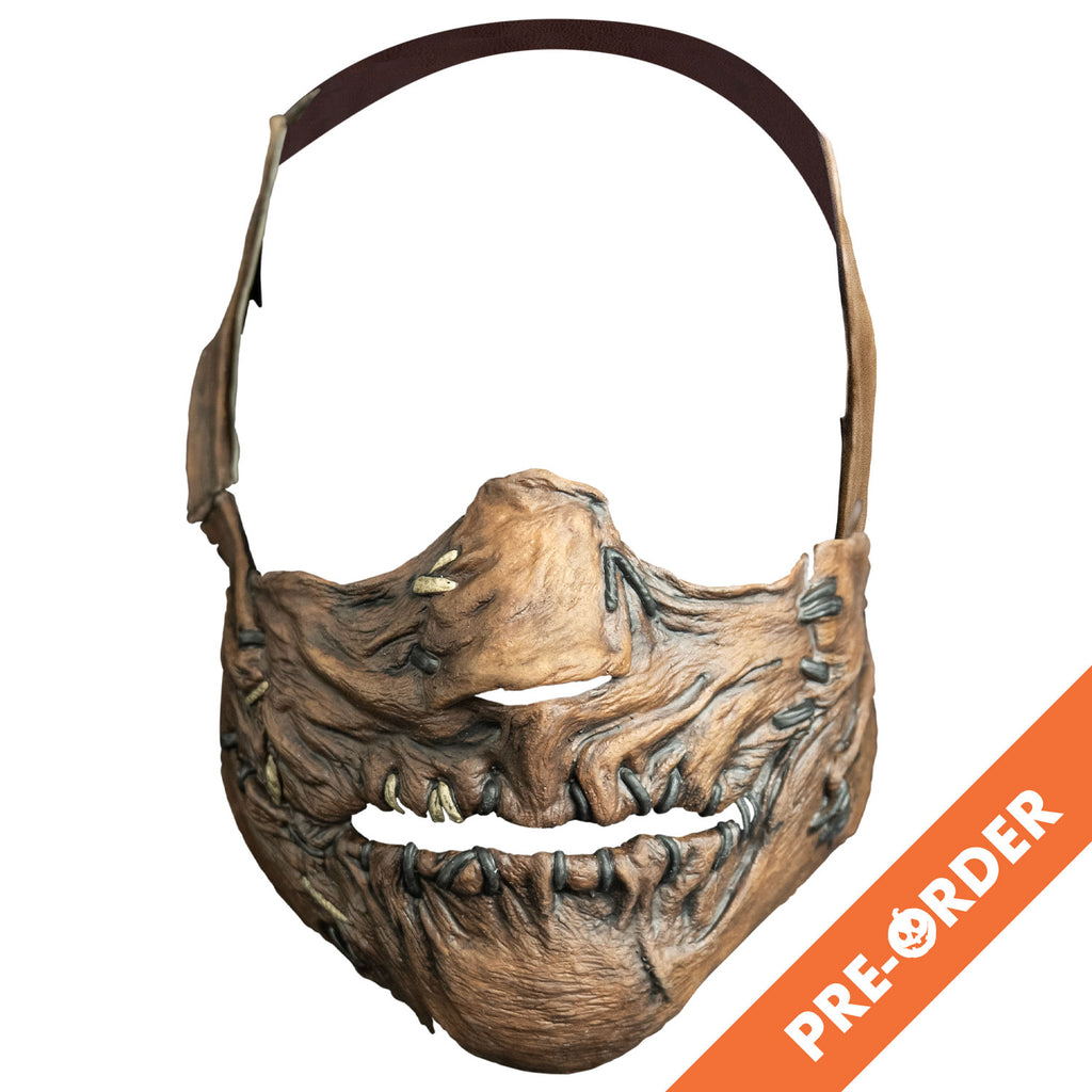 white background, orange diagonal banner at bottom right, whit text reads pre-order. mask, front view. Lower face only, with strap that goes from cheeks around the back of the head. lower face wrinkled flesh sewn together at nose, sides of mouth and lips