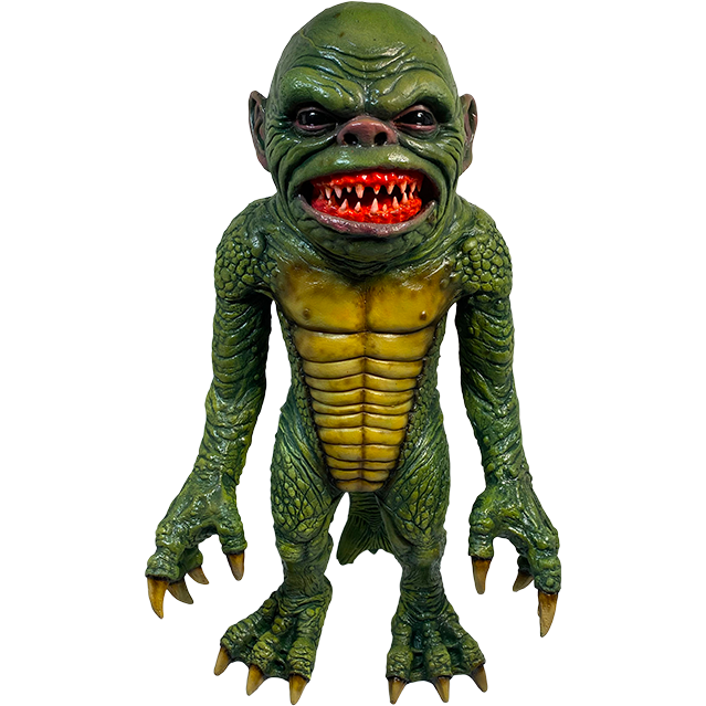 Puppet Prop. Mask, front view. Green scaly face, bulging veins, black shiny eyes, small snub nose. Large frowning fish mouth with large sharp yellowed teeth.  Chest and torso have large yellow scales.  Arms and legs covered in green scales, hands and feet are webbed with sharp yellow claws. Long fish tail.