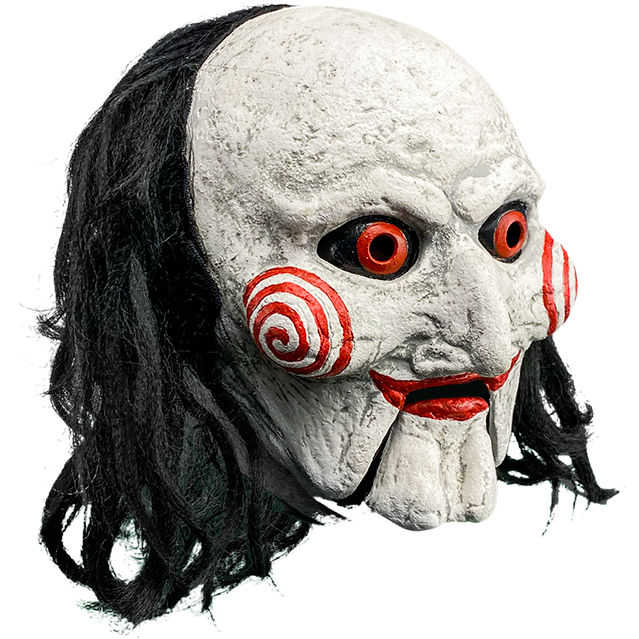 Mask, right side view. Saw Billy puppet, balding with black hair, white face, black-rimmed red eyes, red spirals on cheeks, red lips on hinged ventriloquist dummy mouth.