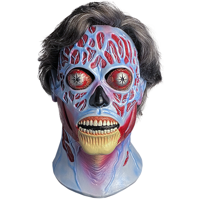 Mask, head and neck, front view. They Live Alien, short salt and pepper hair, blue and red skull like face, silver bulging eyes, black nose, mouth open, exposed teeth and bony chin. 