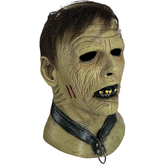 Zombie mask, right side view. Brown hair, wrinkled flesh, slightly open mouth with black lips and jagged teeth. Wearing a black collar with metal ring.