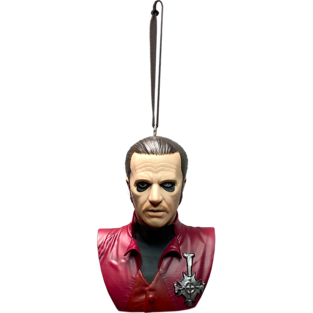 Ornament. Ghost Cardinal Copia bust, front view. Head, neck and chest of man. Slicked back dark brown hair with gray streak, black-rimmed eyes, left eye blue, right eye black. Wearing black shirt under red jacket with silver medallion on left of chest. 