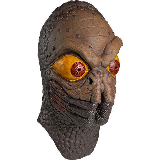 Mask, head and neck, right view. Brown, wrinkled and bumpy skin. Heavy brows large red and yellow eyes, two large nostrils under eyes, insect-like mouth.
