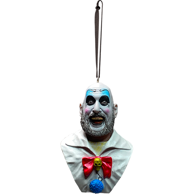 Ornament.  Captain Spaulding bust. Head, shoulders and upper chest. Bald man in white clown makeup, high black eyebrows, blue eyeshadow, black circles around eyes, pink spots on cheeks, large menacing grin, full gray beard, wearing yellow shirt under white collared shirt with red bow, skull pin, blue pompom.