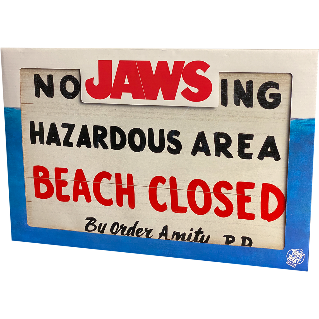 Product packaging, blue and white, window shows sign. Red Text reads Jaws.  White Trick or Treat Studios logo at bottom right.