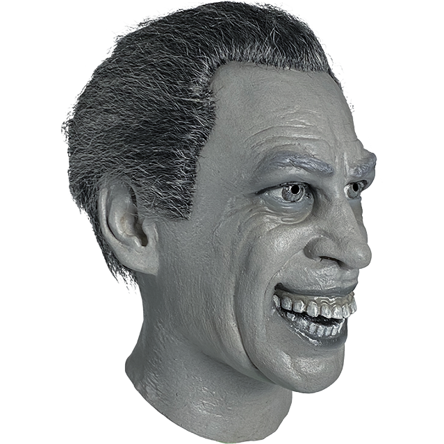 Mask, head and neck, right view. Monochrome, black and white, short salt and pepper hair, wrinkles on forehead, gray eyebrows, gray eyes, large menacing wide mouth grin with teeth showing.