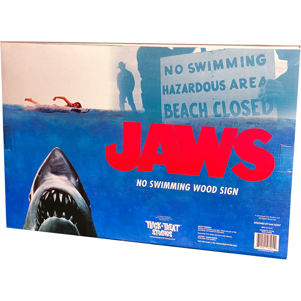 Product packaging back, blue and white, shows scene from movie. Red Text reads Jaws. Manufacturing and licensing information.