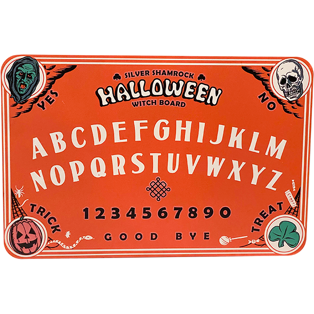 Orange Witch board. Top left corner green witch face, text reads Yes. Top right corner skull face, text reads no. Bottom left Jack o' lantern, text reads Trick. Bottom right corner, green shamrock, text reads Treat. Center of board, top to bottom text reads Silver Shamrock Halloween Witch Board. entire alphabet a through m and then N through Z, numbers 1 through 0 text at bottom reads Good Bye. 