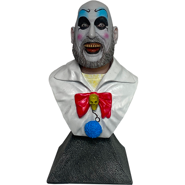 Mini Bust.  Head, shoulders and upper chest, set on stone textured gray base.  Bald man in white clown makeup, high black eyebrows, blue eyeshadow, black circles around eyes, pink spots on cheeks, large menacing grin, full gray beard, wearing yellow shirt under white collared shirt with red bow, skull pin, blue pompom. Set on gray stone-textured base.