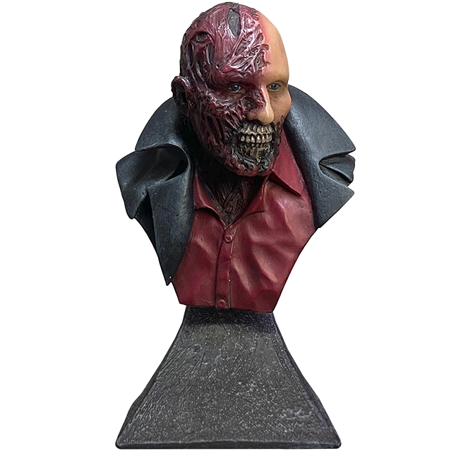 Darkman Mini bust. Head shoulders and upper chest.  Bald with Grotesque skin on entire right side of face and neck, and the left side from the cheekbone down. Mouth is missing lips, exposing teeth and portions of the upper and lower jaws.  Collar and shoulders of black trench coat over a red button-up shirt. bust set on stone textured bust stand.