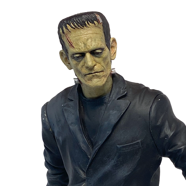 Frankenstein statue, close up detail of head number one and chest. Pale greenish skin short black hair, metal bracket on top left forehead, wound on right side of forehead, heavy brow, dark circles around eyes, dark lips, metal bolts on sides of neck. Dirty black suit.