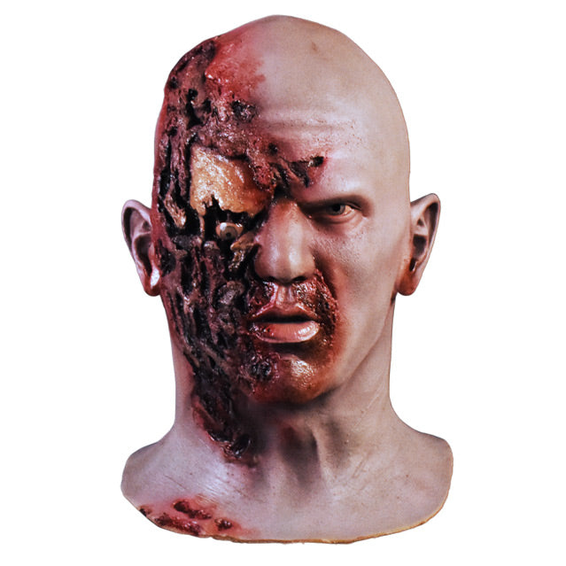 Front view. Airport Zombie mask. Head and neck. Bald zombie, right side of face and neck is gory, right eye is misplaced and hanging.