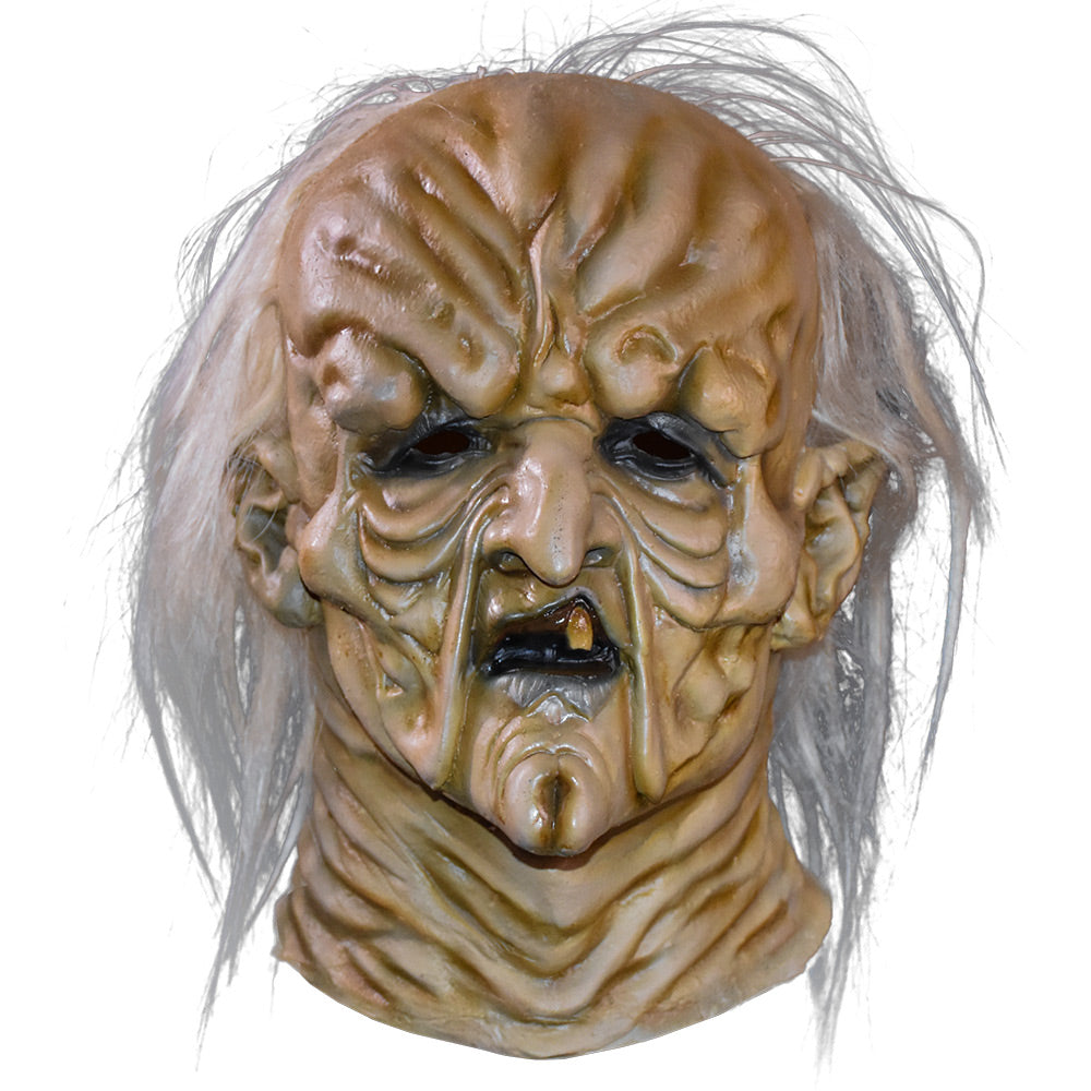 Mask, front view.  Head and neck. Wrinkled saggy, misshapen flesh on face.  Balding with long white stringy hair.  Black rimmed eyes, small mouth with black lips and only one tooth.