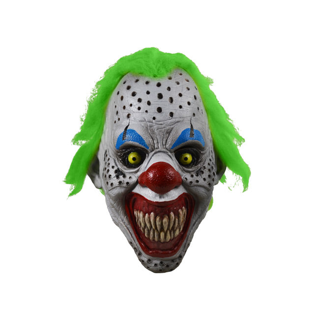 Front view.  Scary Clown face.  Bright green hair, white skin with black holes, black ringed yellow eyes with blue eyebrows, large bright red nose, large red clown mouth smiling with large sharp teeth.  