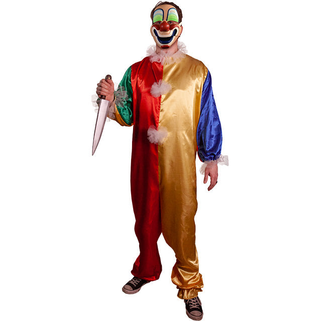 Person wearing clown mask, and green, red gold and blue clown jumpsuit with tulle ruffles on neck and cuffs, tulle pompoms on front.  Black and white sneakers.  Holding large butcher knife in right hand.