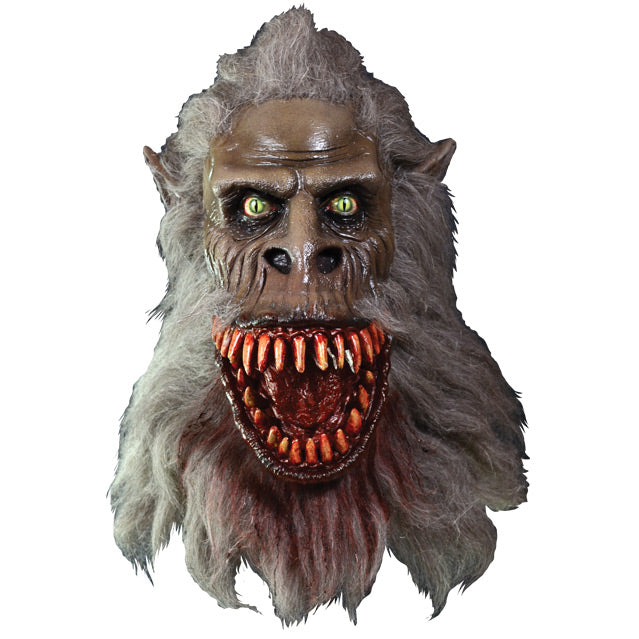Front view. Crate Beast mask. Light brown beast face, wrinkled skin, Yellow eyes with vertical long pupils, pointed ears, snout nose, large grinning bloody mouth with many sharp teeth, long gray fur covering head, lower face and neck.  Blood stains on fur around mouth and chin.