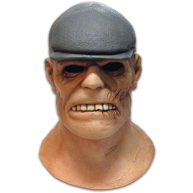 Mask, Head and neck.  Man wearing gray Irish flat cap.  Scarred face, wide mouth with large teeth, large prominent jaw.  Cauliflower ear