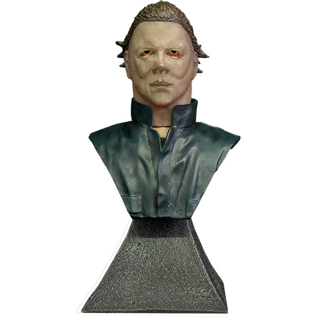 Front view. Michael Myers mini bust. Head neck and chest, Tan mask, brown hair, black shirt under dark coveralls. Gray stone textured base.