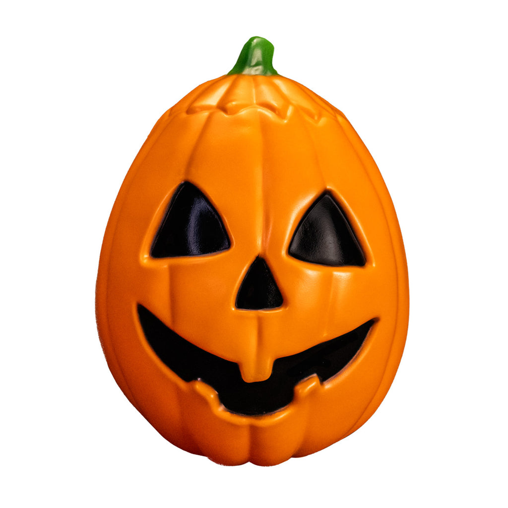 Pumpkin prop, front view.  Orange jack o' lantern, green stem, black triangle eyes and nose, grinning black mouth.