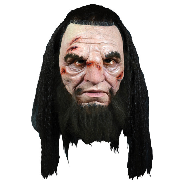Front view, Wun Wun mask. Head and neck.  Man with wounds on face, thick bushy black eyebrows, long bushy black beard.  long black hair, pulled back on top.