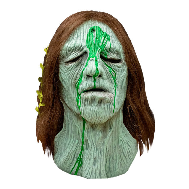 Front view, Creepshow Becky Mask, Zagone edition. Head and neck of woman. Red brown straight hair, with seaweed in it, green wrinkled mossy skin, eyes appear closed. hole in forehead oozing dried green fluid.
