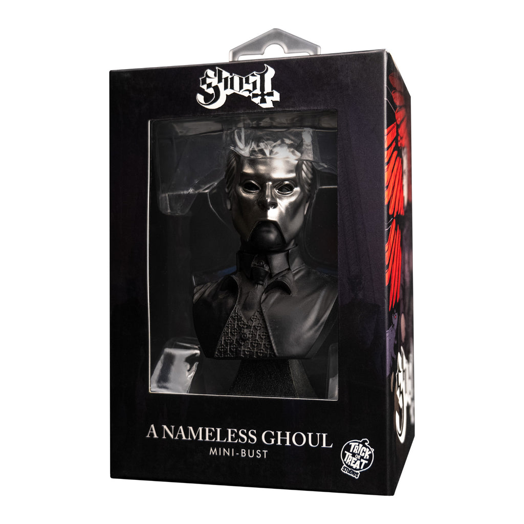 Product packaging, black window box with Ghost, Nameless Ghoul mini bust inside. Head neck and chest of man, wearing chrome facemask with horns on face. Black shirt, tie and vest under black jacket. Set on gray stone textured base. Text on box reads Ghost, A Nameless Ghoul mini bust. white Trick or Treat Studios logo