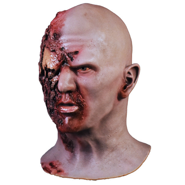 Left side view. Airport Zombie mask. Head and neck. Bald zombie, right side of face and neck is gory, right eye is misplaced and hanging.
