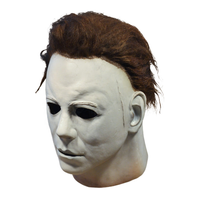 Michael Myers mask, Left side view. Head and neck. Dark brown hair, white skin, flesh colored around bottom of neck.