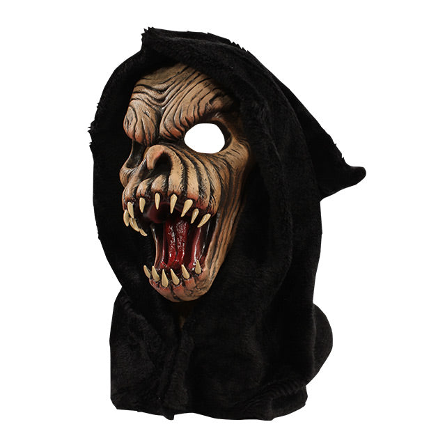 Left side view. Brown faced creature in black hood, wrinkled skin, wide open mouth showing tongue and several large fangs.