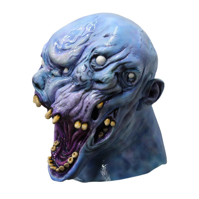 Left side view. Gray Matter Mask, head and neck. Grey blue distorted head, many white eyes, several misplaced yellow upper teeth, Large gaping grotesque mouth, with lower jaw of human-like teeth. one ear on side of head.