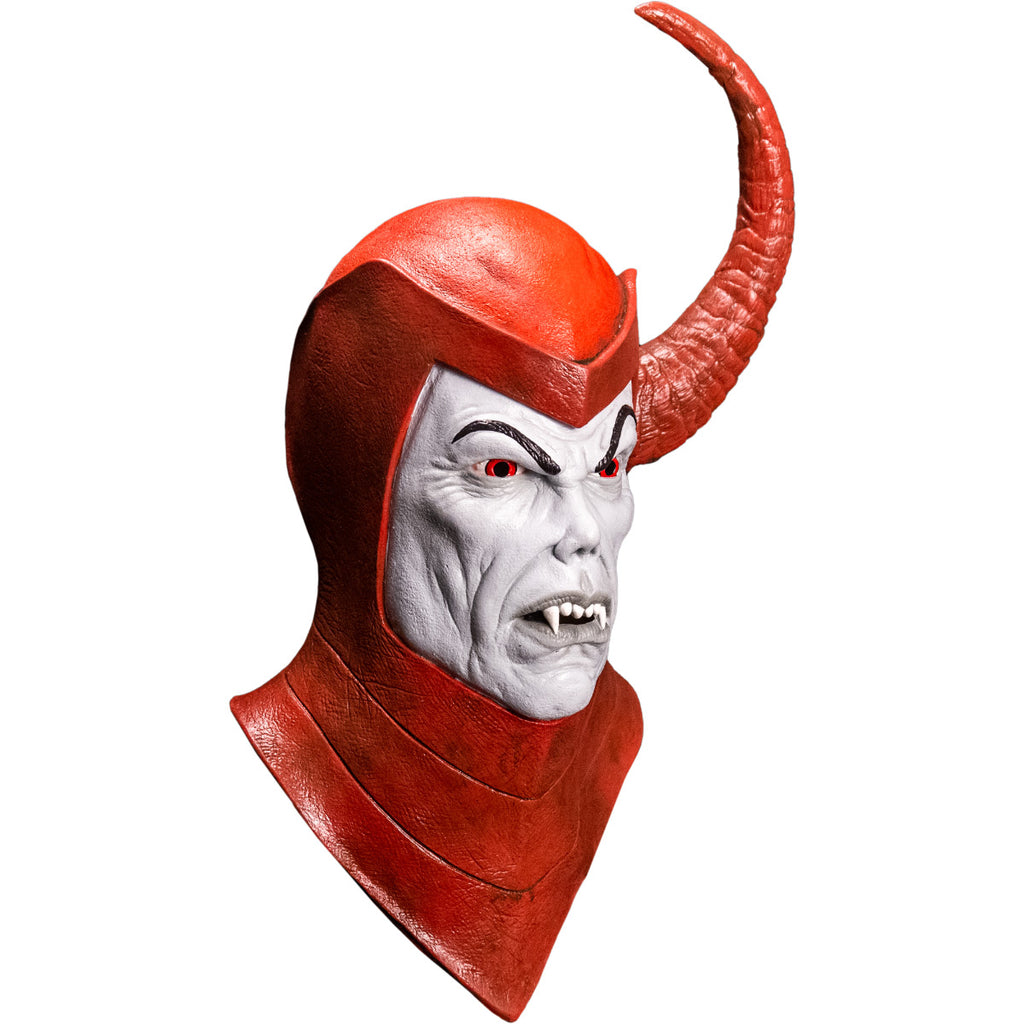 Mask, right side view, head and neck. Red Helmet and cowl, large red horn protruding from left side of head. Light gray face with black eyebrows, red eyes, small nose, mouth with fangs, gray lips.