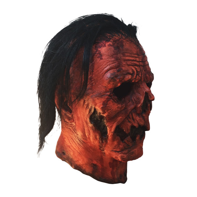 Right side view. Jacob Atkins mask. Gory, wrinkled orange Jack o' lantern-like face with stringy black hair.