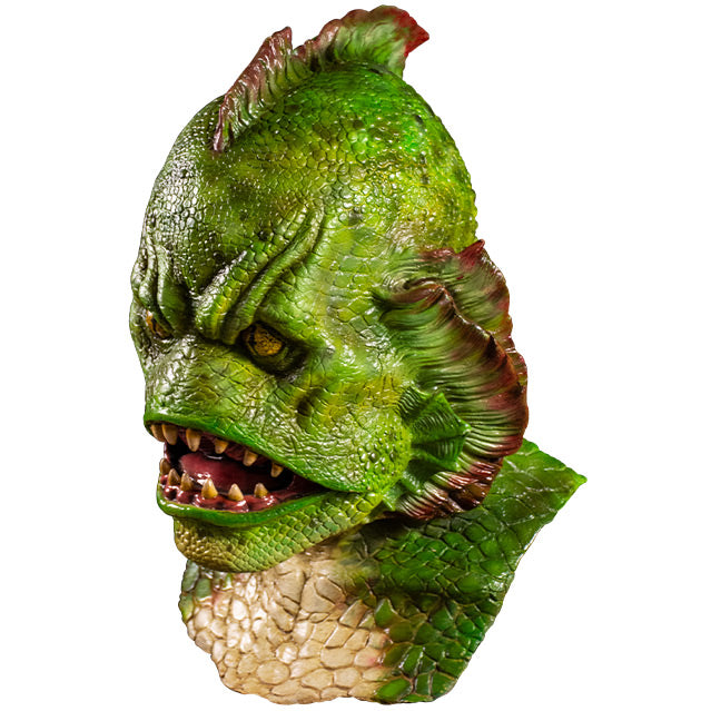 Mask left side view.  Head, neck and upper chest. Humanoid fish creature. Green scales, fin in center of head, fins on each side of face. Yellow eyes. Large open fish mouth with sharp yellowed teeth.